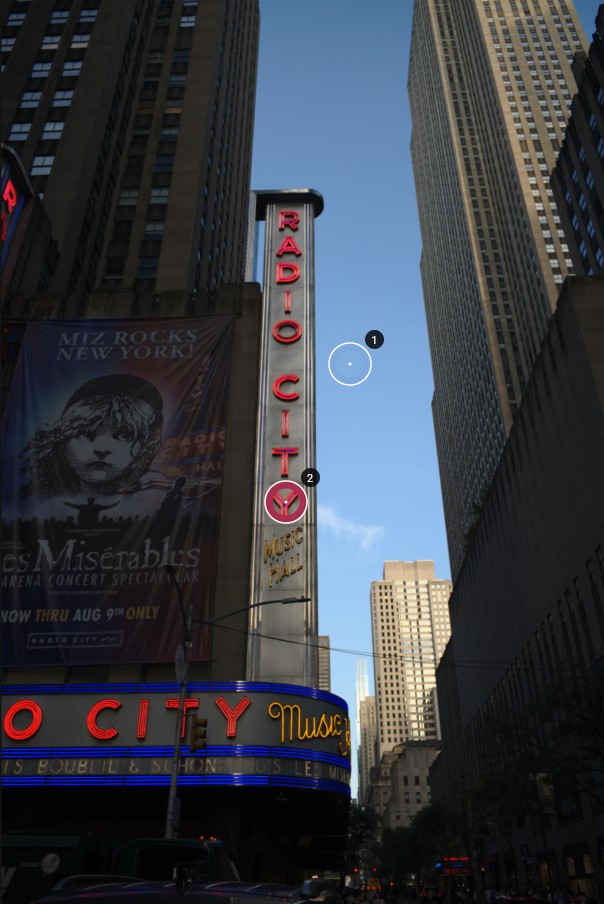 Radio City Music Hall against a blue sky, with two probe points: one in the sky, one on the red sign.